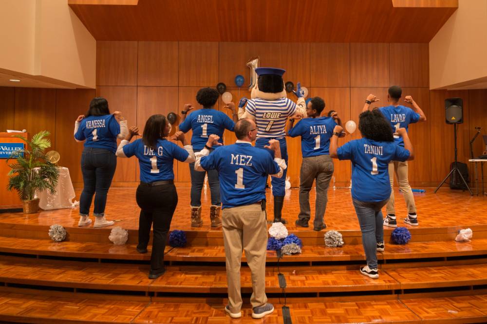 Image of TRIO advisors and directors showing off their nicknames on the back of their tshirts